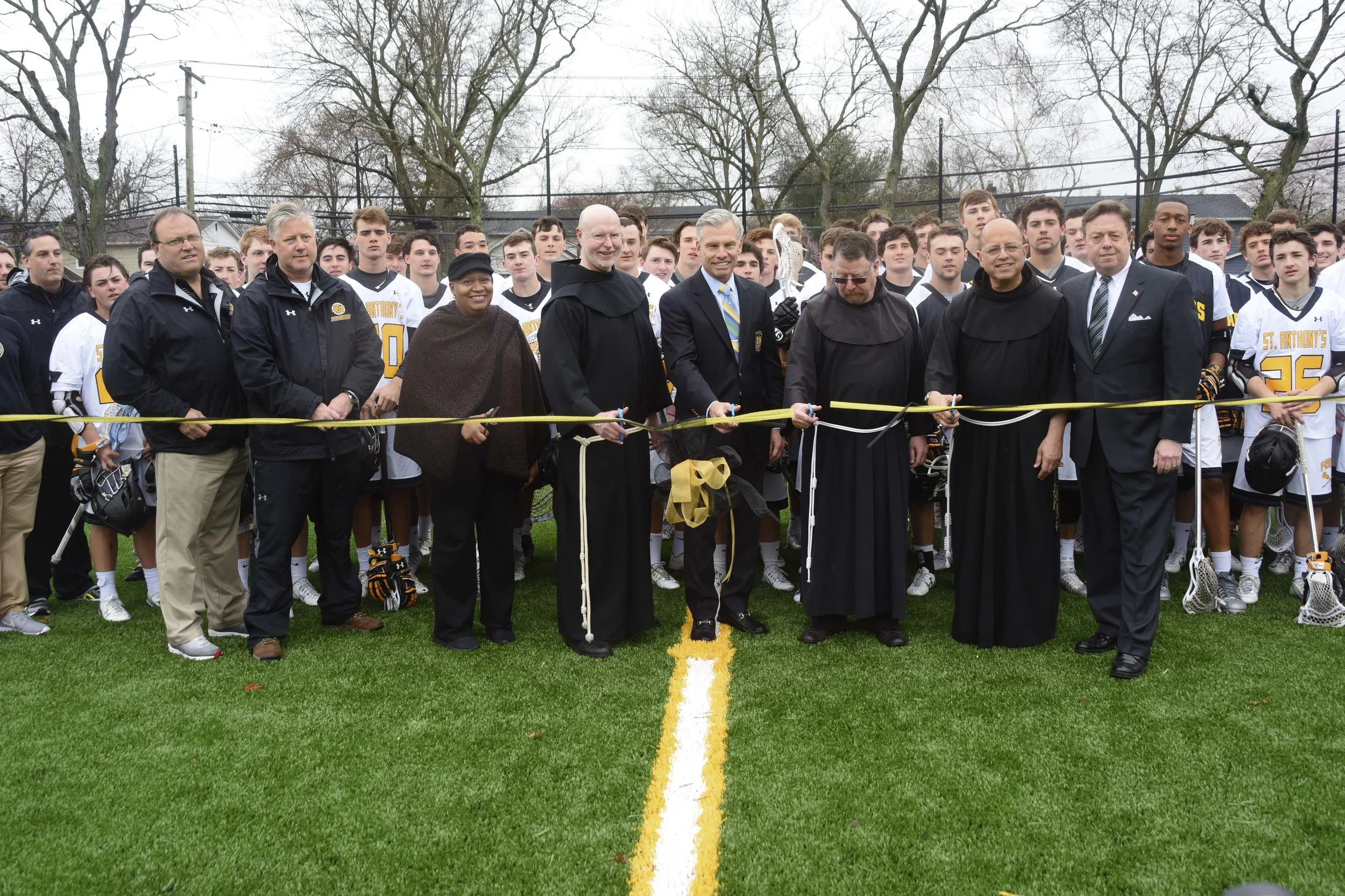 Among those who cut the ribbon at St. Anthony’s High School’s newly-unveiled James C. Metzger Stadium is James C. Metzger; St. Anthony’s Principal Bro. Gary Cregan; Bro. Christopher Thurneau, OSF; Director of Development Don Corrao; Huntington Councilwoman Tracey Edwards; and school administration, lacrosse coaches and members of the varsity lacrosse team. Photo/Ray O’Connor Photography