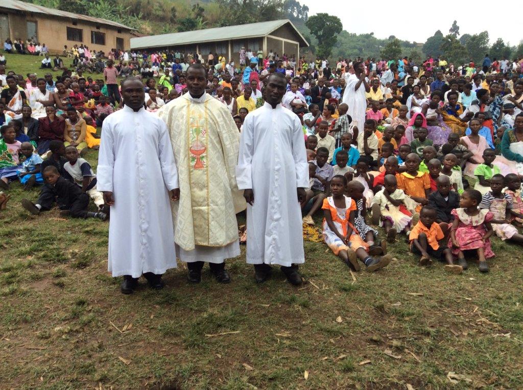 Father Vian Ntegerej’Imana, standing center, is the associate pastor at St. Anthony of Padua Church in East Northport. Students at the church are raising money toward construction of Father Ntegerej’Imana’s home village in Kisoro, Uganda, which is pictured.