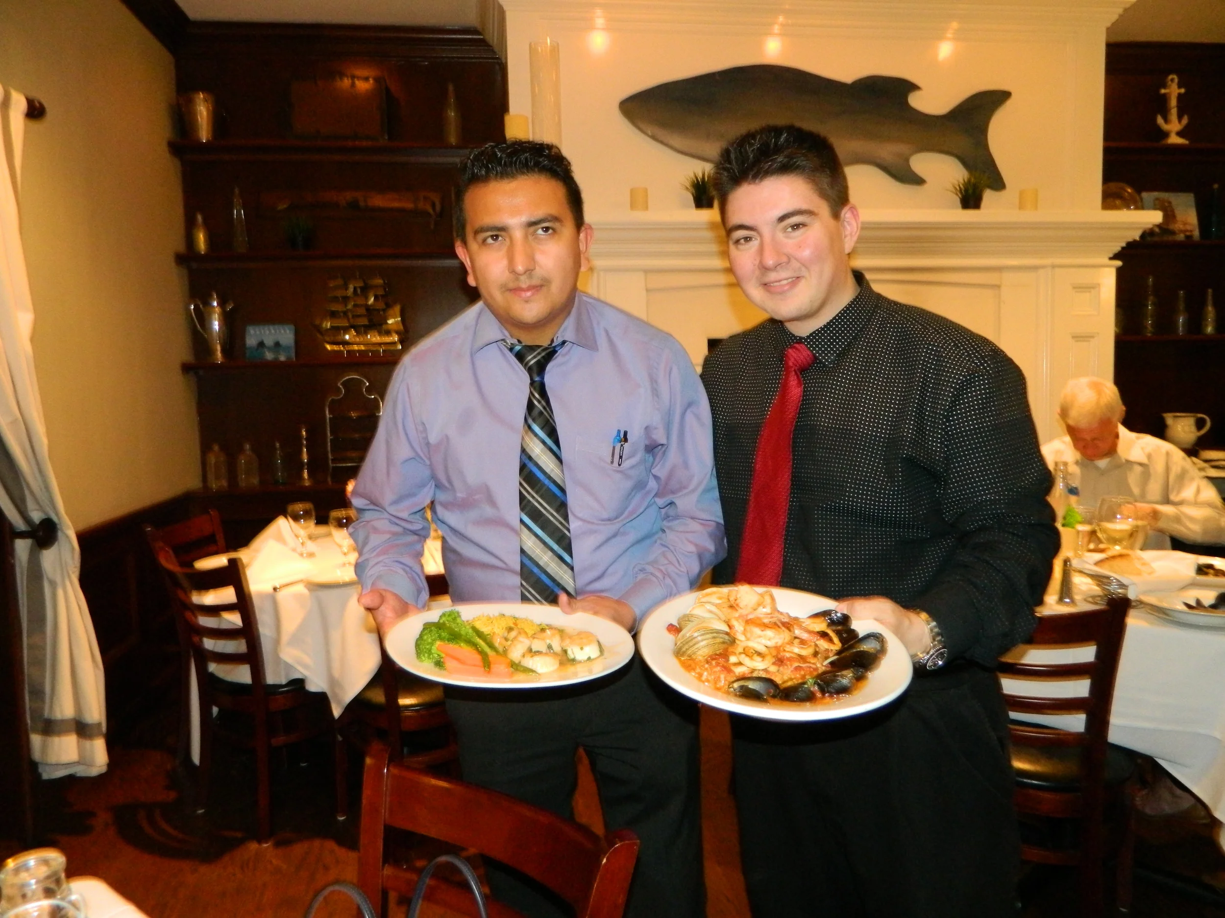 Managers Javier Villatoro, left, and Justin Visconti present Harbor Mist’s seafood risotto and sea scallops entrees.