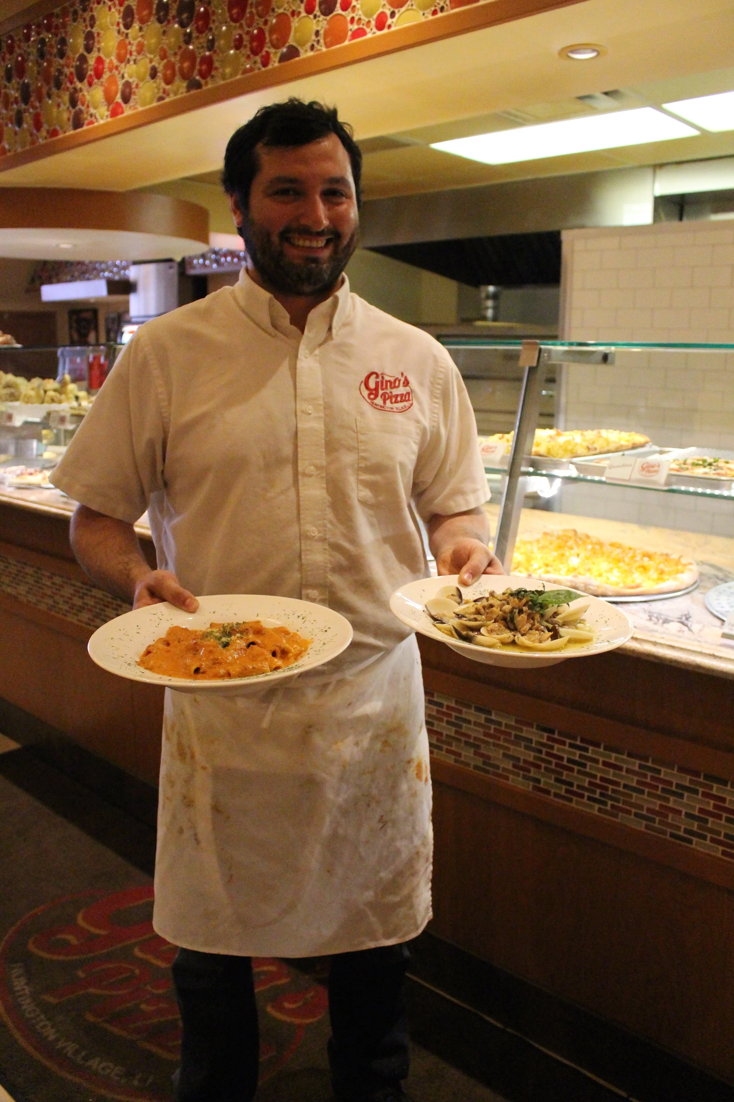 Nick Salerno, owner of Gino’s Pizzeria in Huntington village, serves up rigatoni Bolognese with red wine sauce and linguini in white clam sauce.