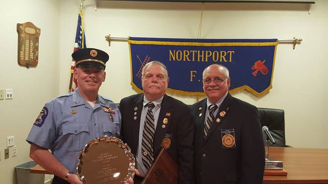 Volunteer firefighter John McKenna receives the Fire Service Community Achievement Award Monday night at the Northport Fire Department. Photo/FASNY