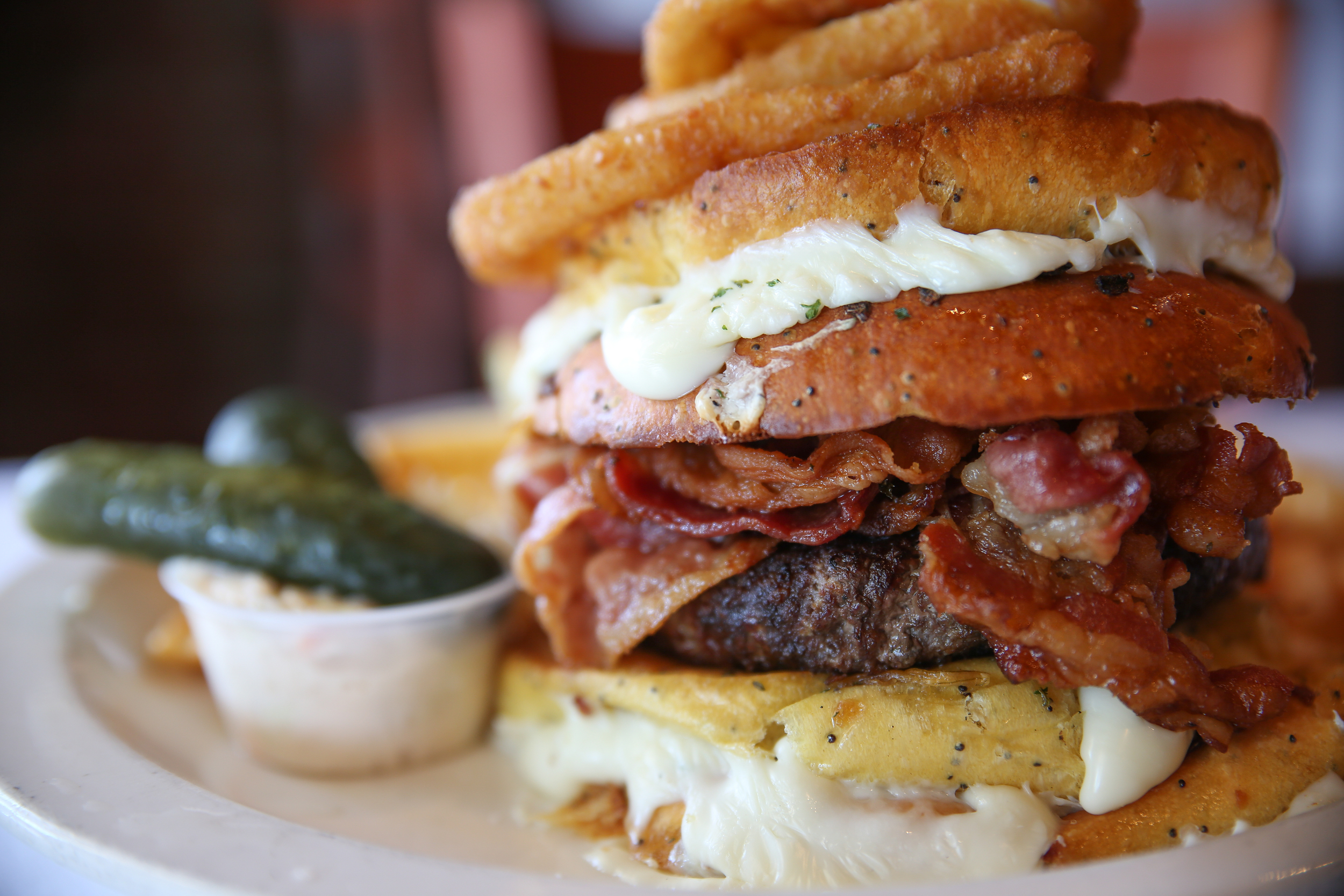 Chef Frank calls the The Bacon Belly Buster burger a “challenge,” boasting two Texas toast grilled cheese sandwiches instead of buns, surrounding a beef burger with bacon. 