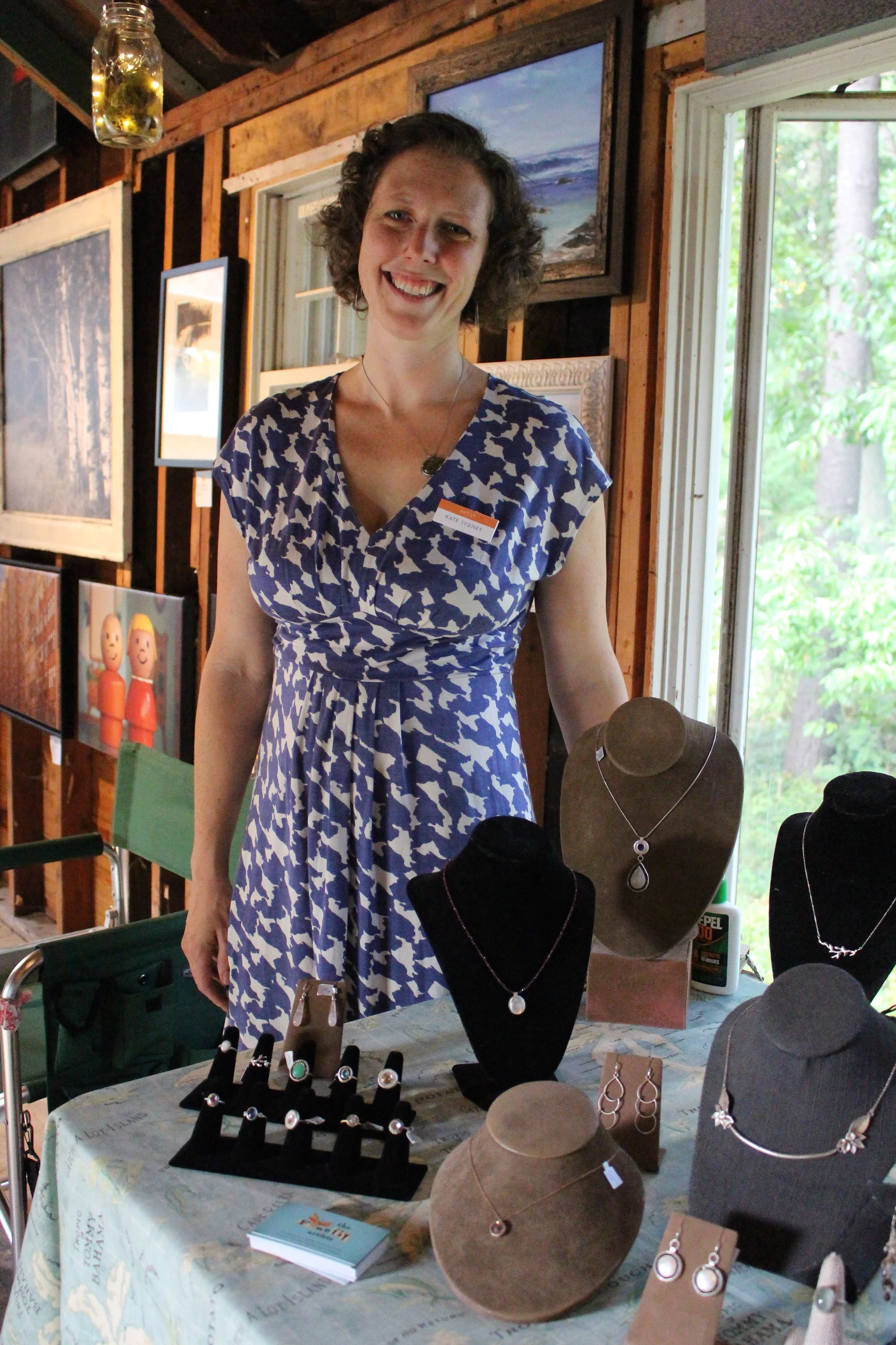 Long Islander News photos/Janee Law Kate Gilmore, co-founder and managing partner of Firefly Artists, stands next to her table of jewelry at the Firefly Artists’ pop-up gallery event that was hosted in Eatons Neck over the weekend. 