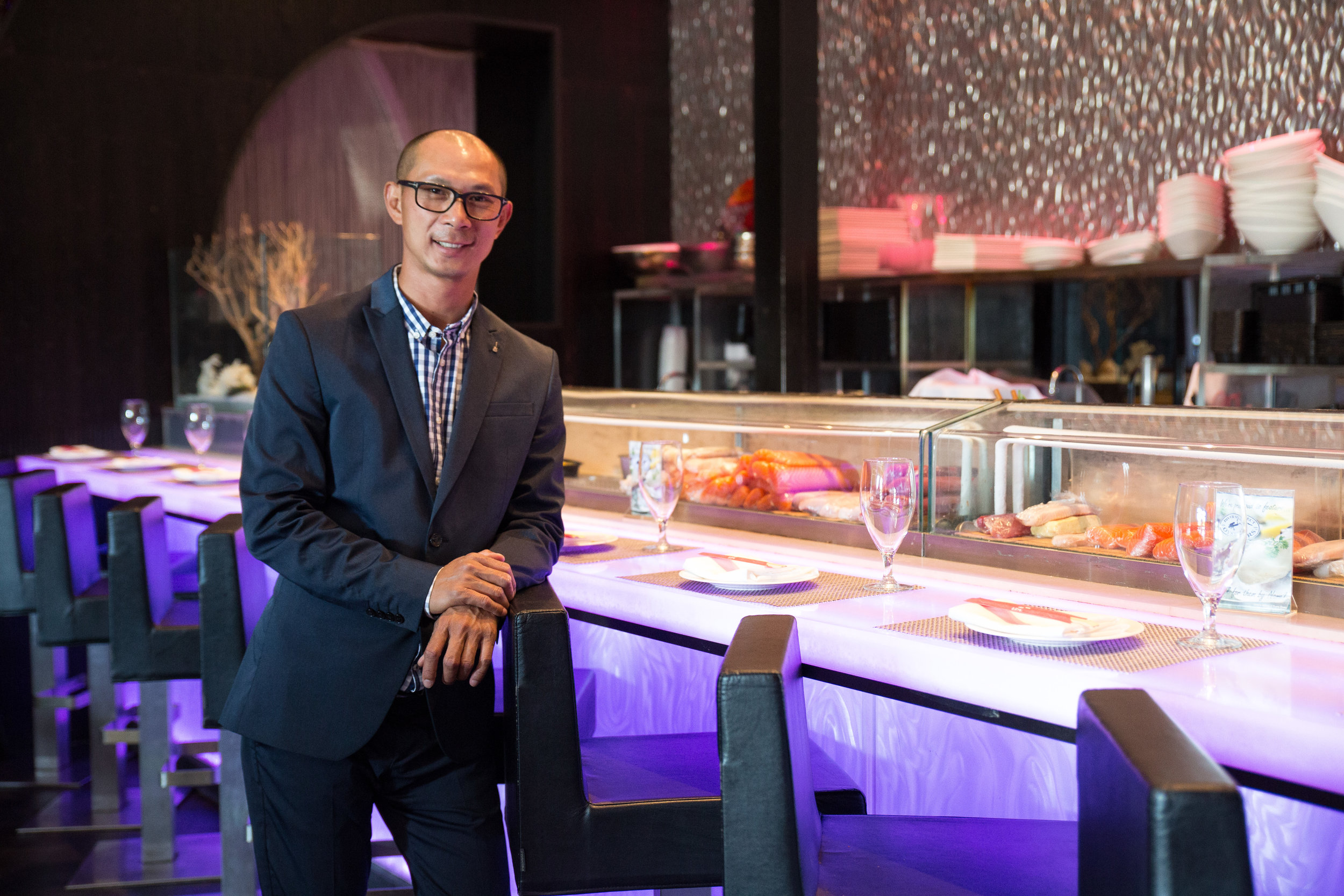 Tom Lam at the bar of Nisen Sushi, a Japanese restaurant with a hip vibe and fresh, creative cuisine.