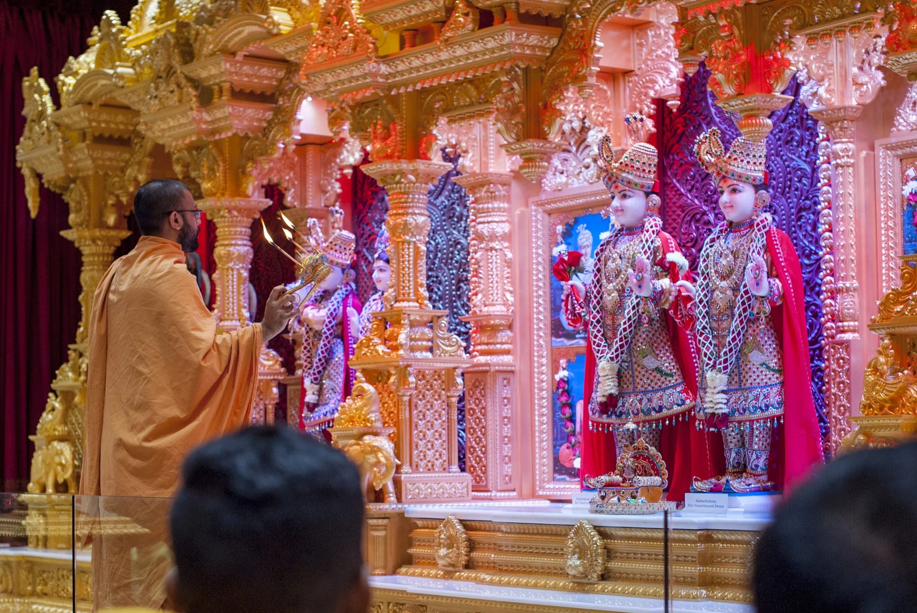 During an evening Arti, the Hindu ceremony of light, attendees clapped and chanted mantras in praise of their guru.
