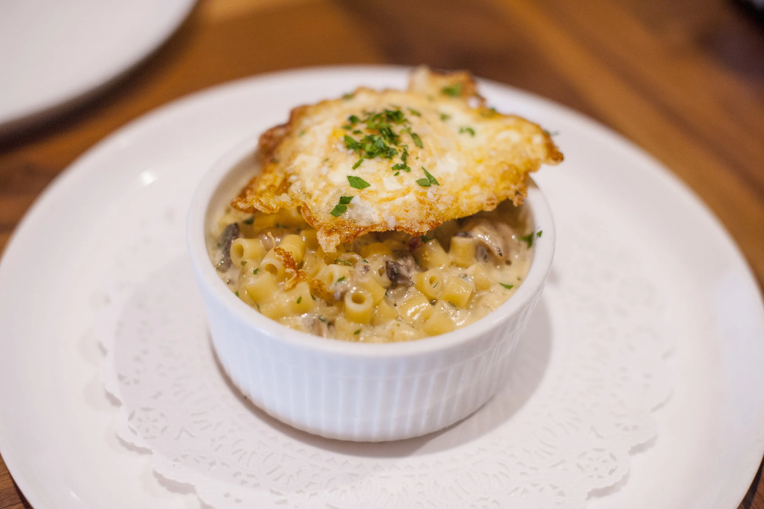 The three-cheese Italian Mac and Cheese combines parmigiana regiano, gorgonzola, and mozzarella with an organic friend egg for a decadent appetizer.