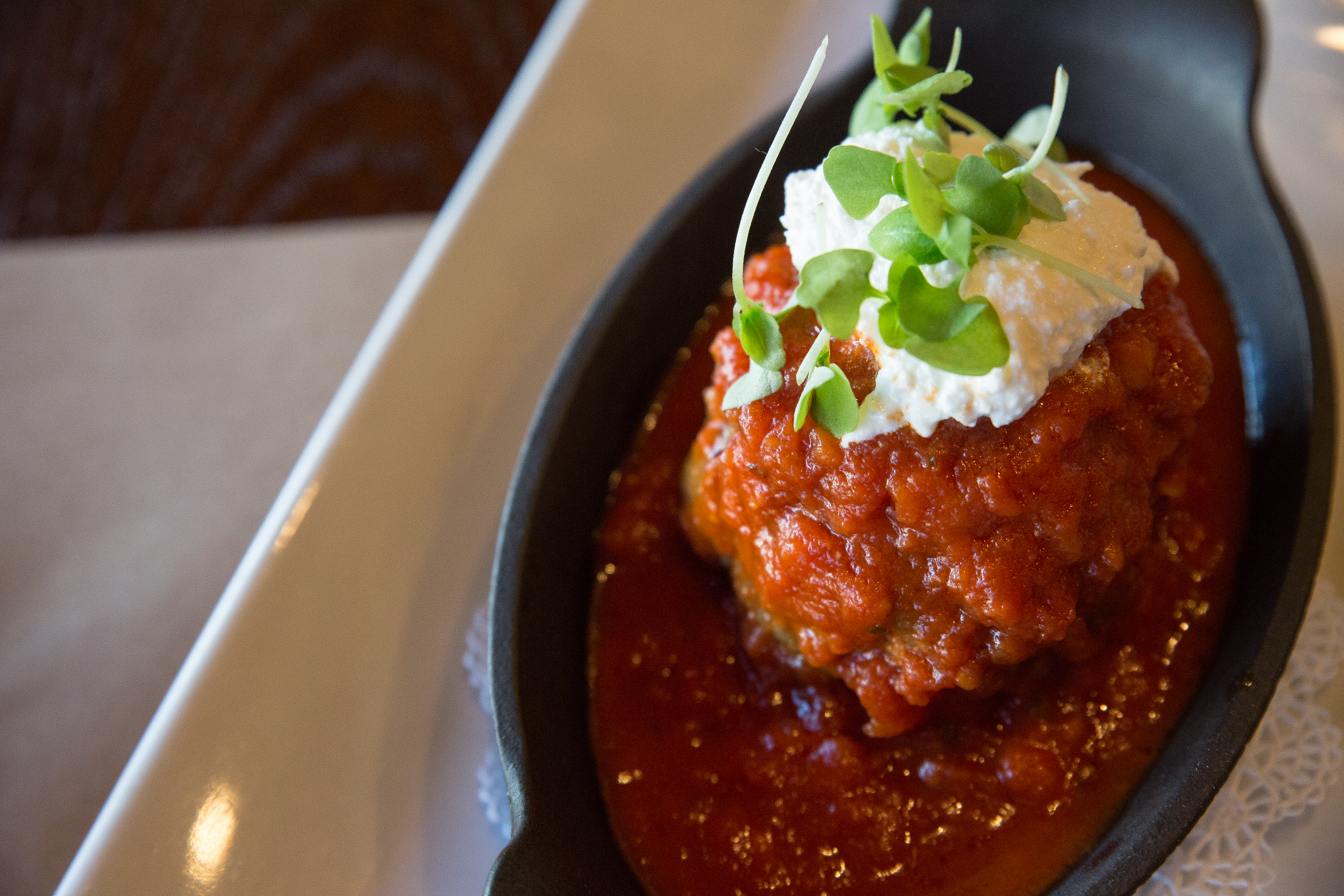 The Polpetta housemade meatball integrates hearty seasonings, topped with a creamy ricotta, is an appetizer that takes one back home.
