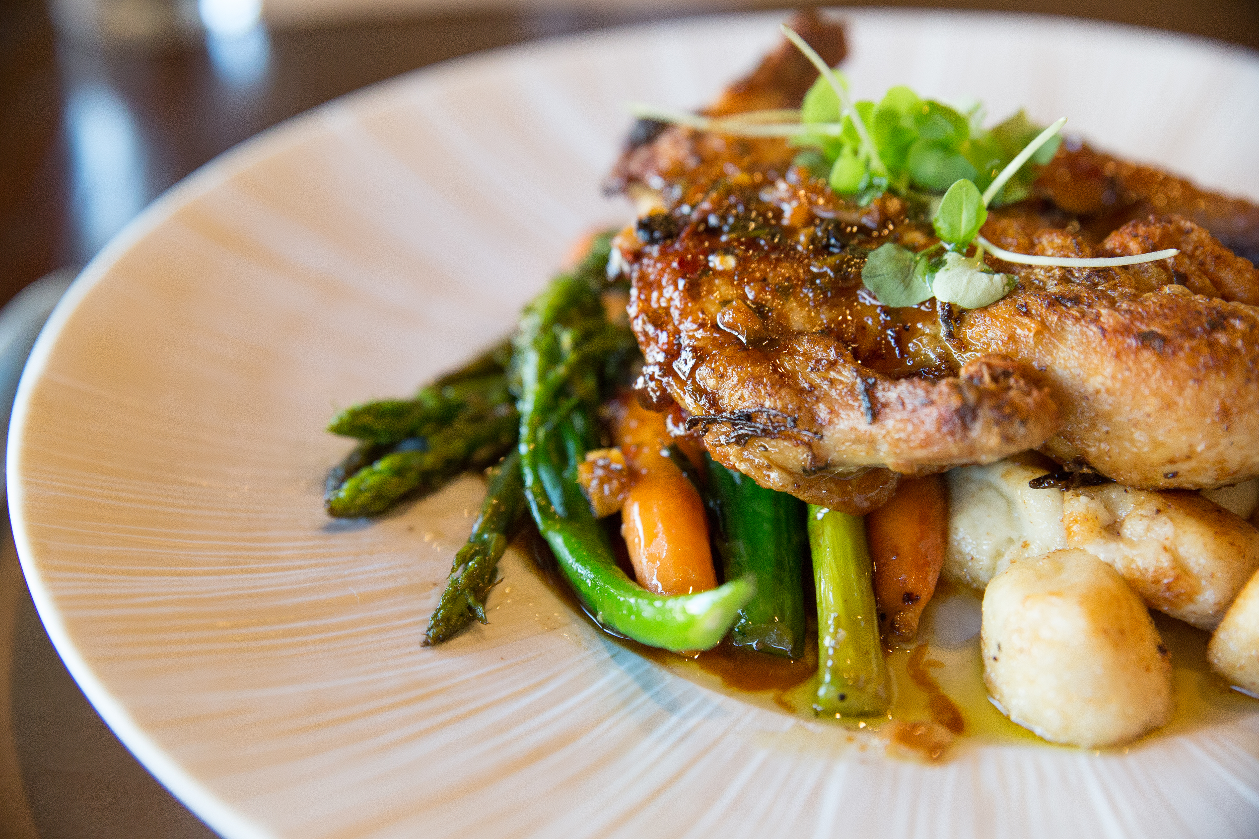 The Pollo Alla Diavola plates a roasted marinated chicken, seasonal vegetables, fried gnocchi drizzled with a savory rosemary pan jus.