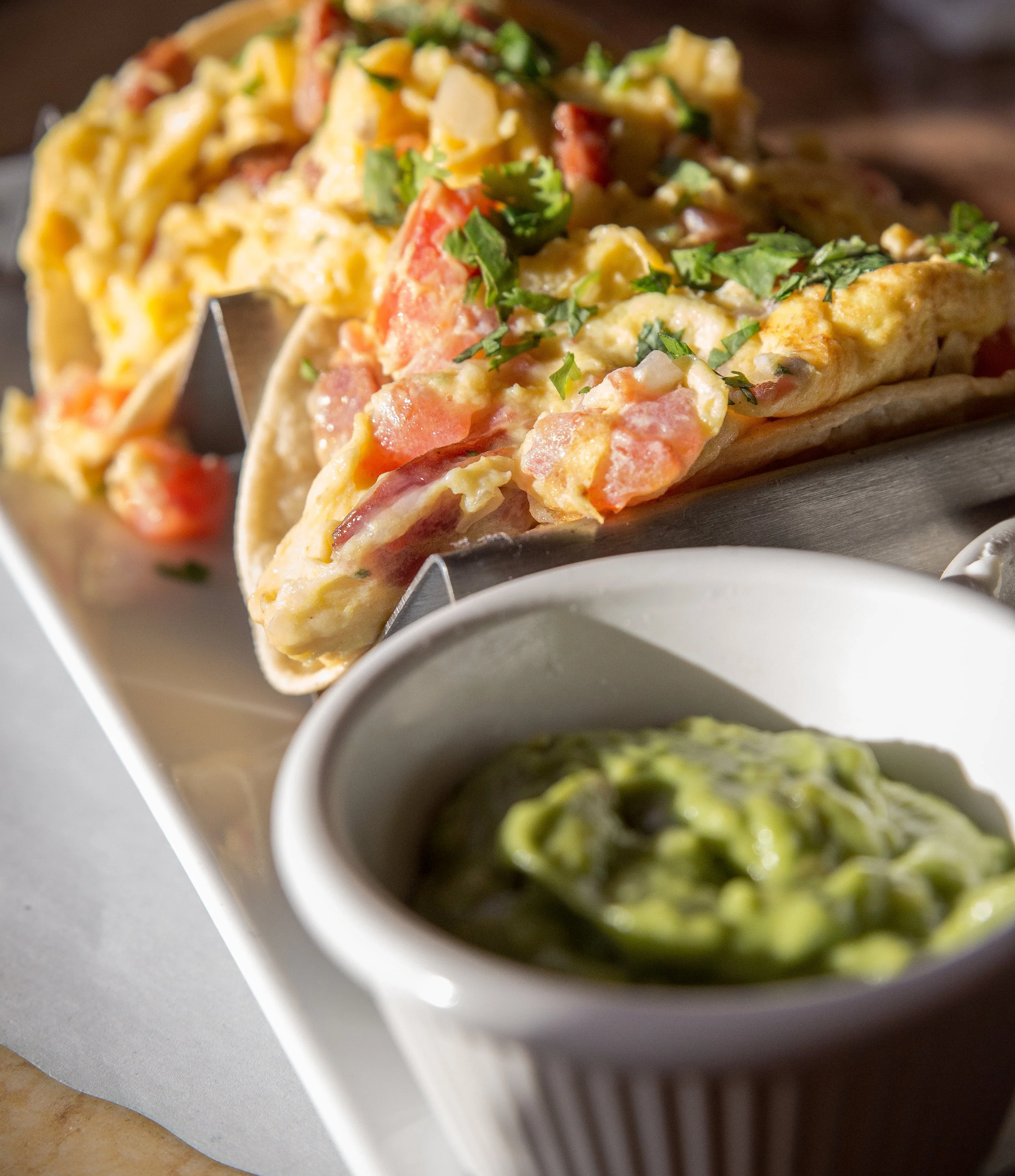 The bold Breakfast Tacos are filled with scrambled eggs, chorizo, jack cheese and pico de gallo, with sides of sour cream and guacamole that add pack even more flavor into each and every bite.