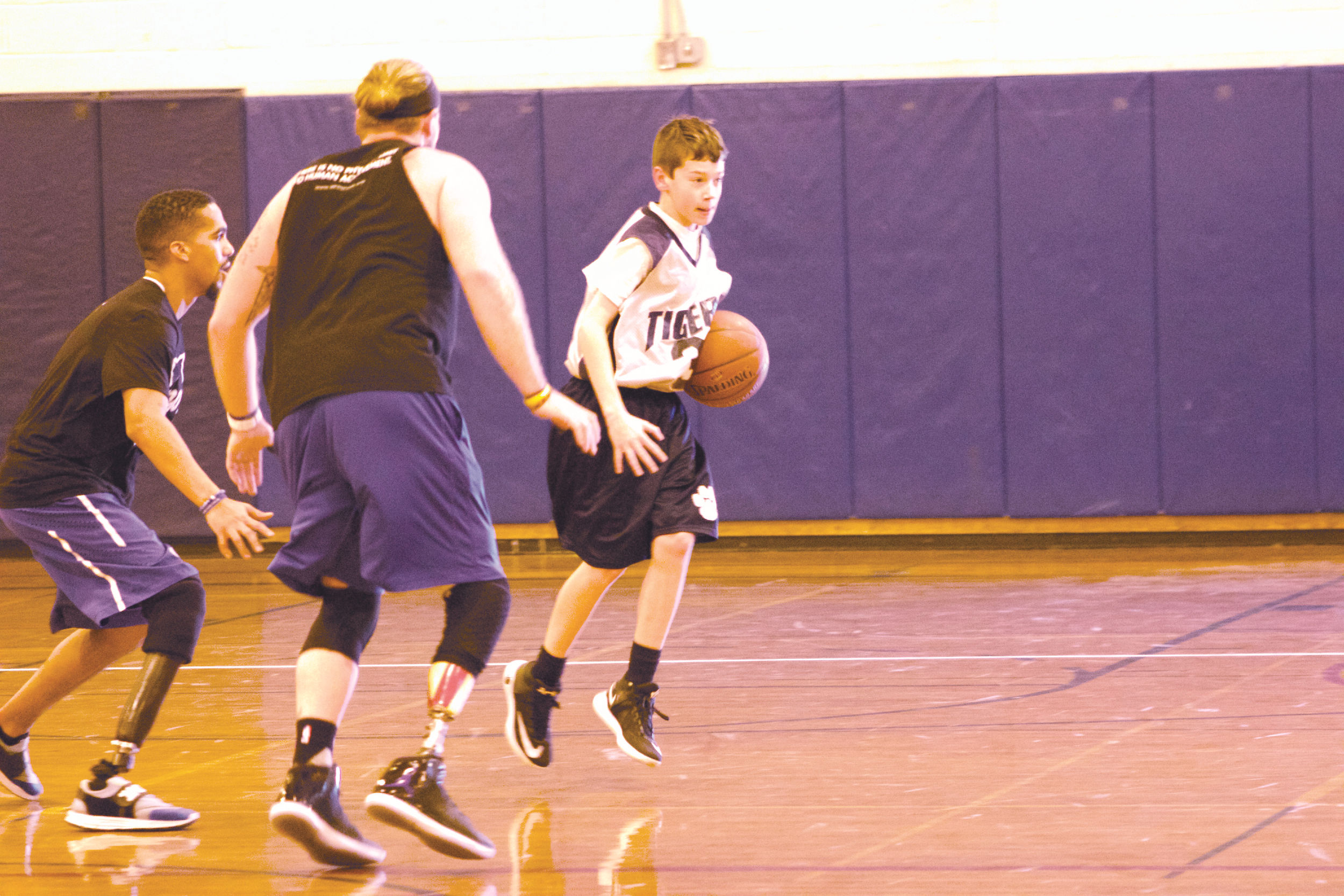 Braden Ciszek (no. 31) shields the basketball away from AMP1 players Robert Rodriguez and Nick Pryor at Northport Middle School on Friday.