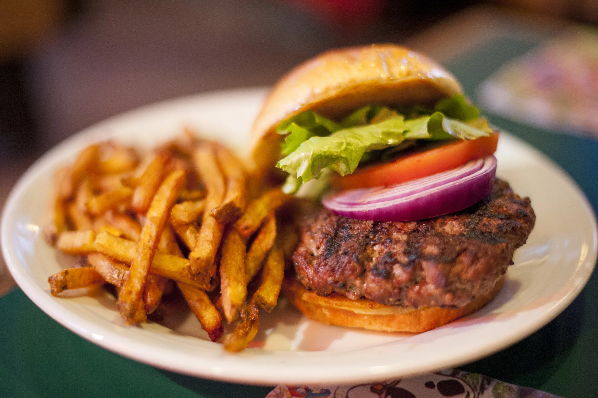 The All American Burger served with seasoned fries is a heaven of traditional savory tastes, all between a light and fluffy bun that let’s its contents take the spotlight.