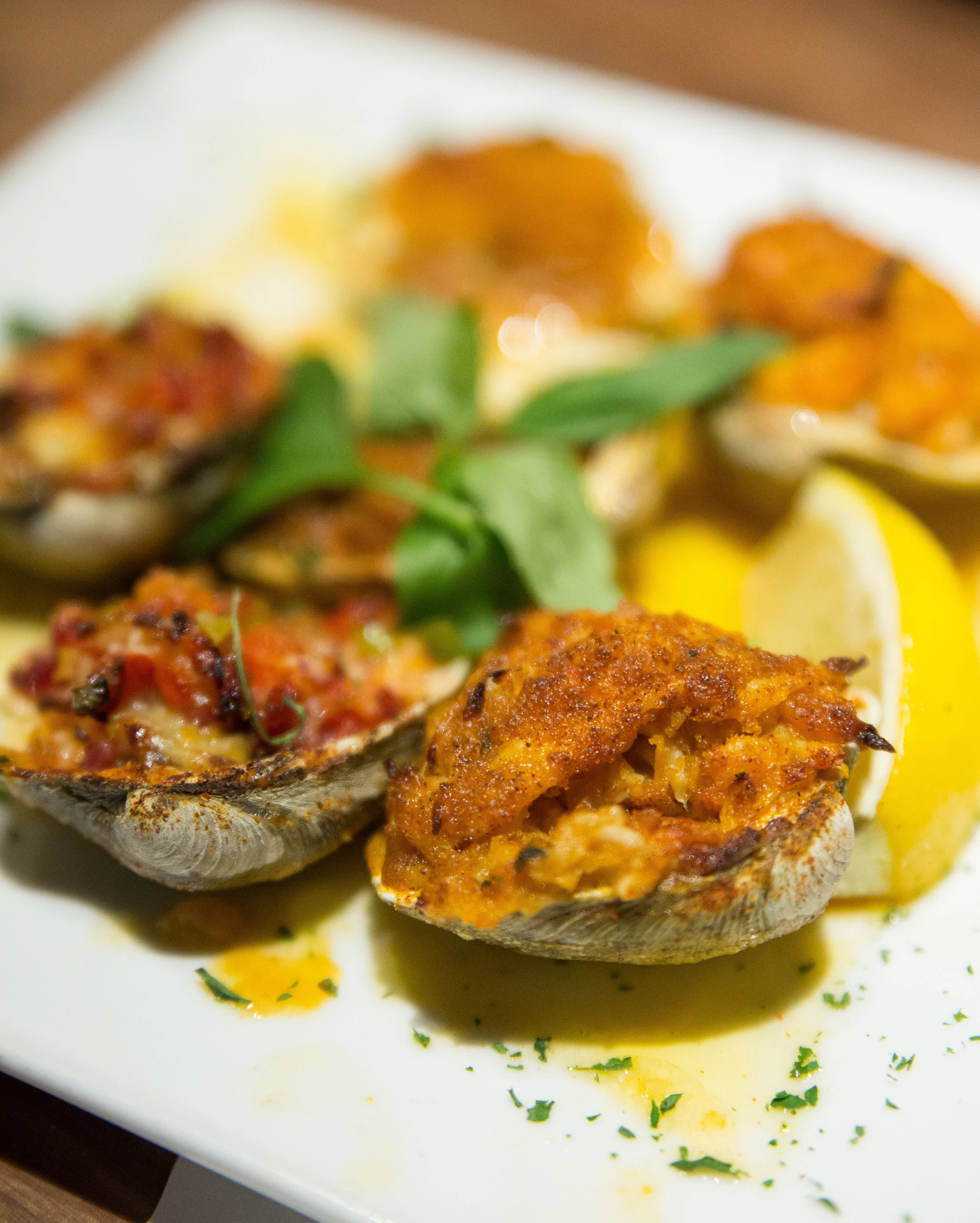 The Clams Trio special plate features a variety of antipasti menu items including two Baked Clams, Clams Casino and Stuffed Clams, which all brimmed with impeccable freshness.
