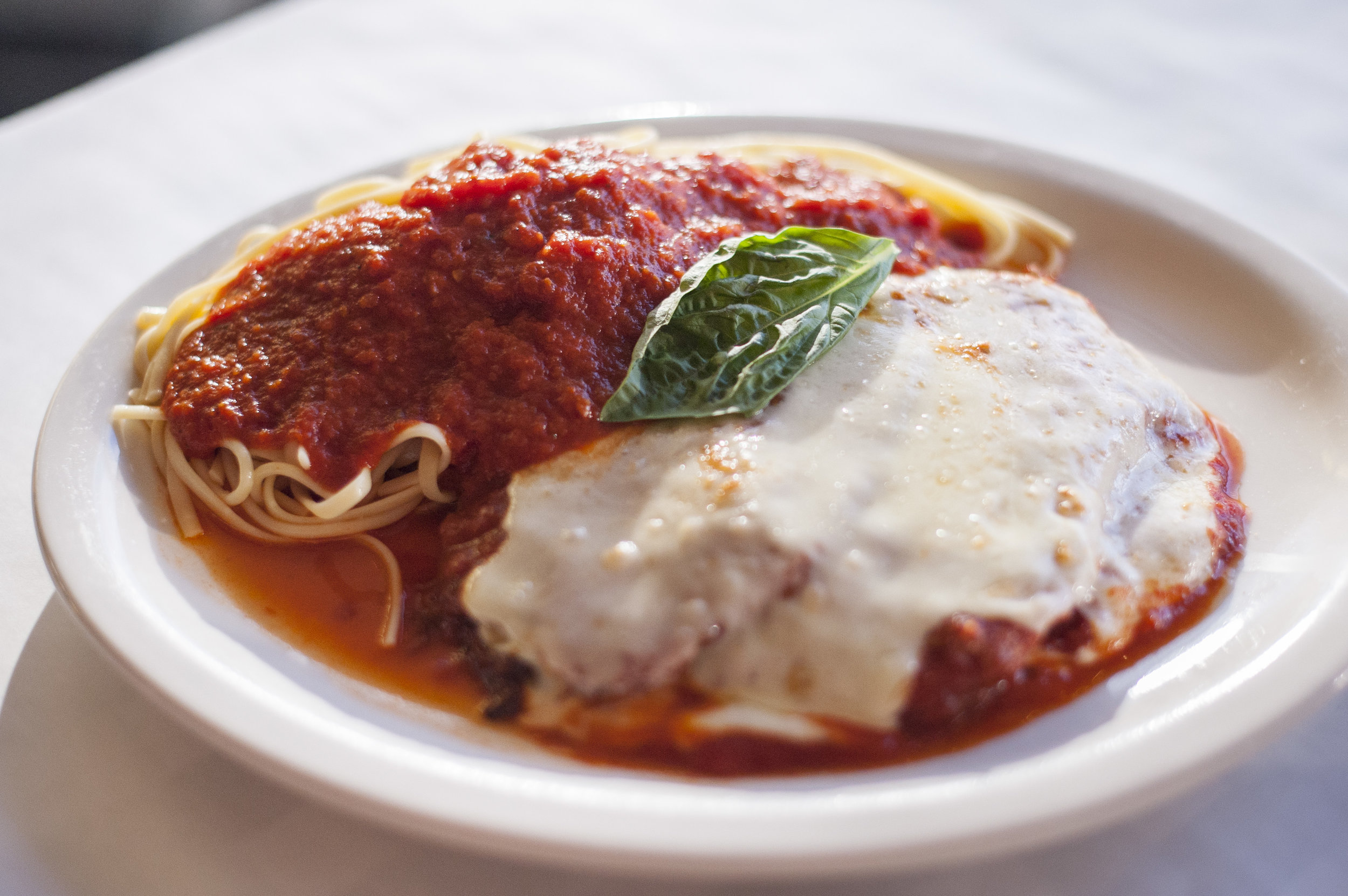 The one-of-a-kind Eggplant Parmesan with linguini features plum tomato sauce, topped with melted mozzarella cheese, all sans breadcrumbs, lending itself to a purer, earthy experience.