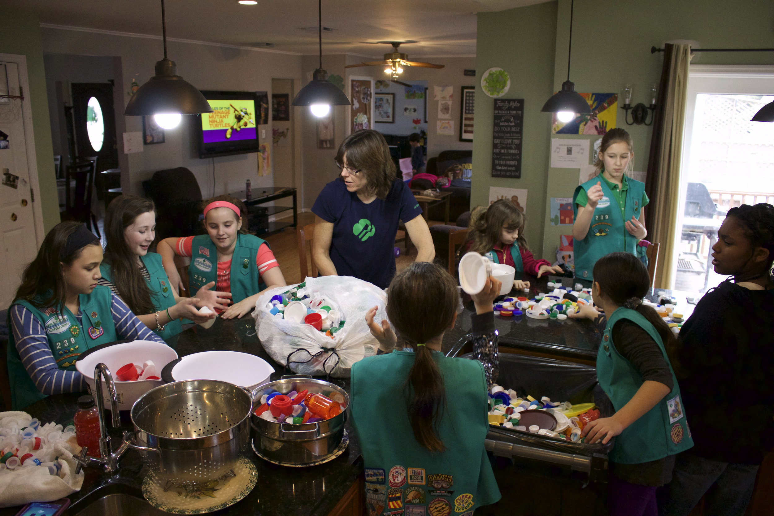  Co-leader Christine Reilly and Girl Scout Troop 239 spent Saturday going through pounds of plastic caps and lids that can be turned into their second bench, with the daily goal to reach 80 pounds of plastic. 