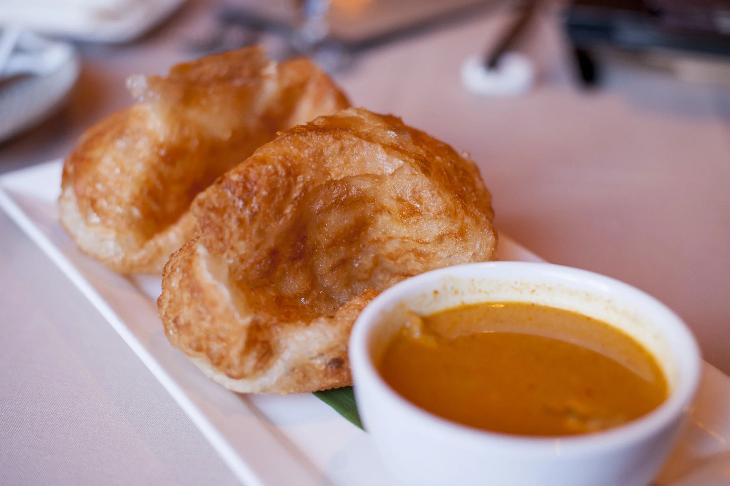  Ting’s Roti Canai is a crispy and flakey Indian flatbread served with side of curry sauce with french fries that easily absorb the curry’s aromatics and spices. 