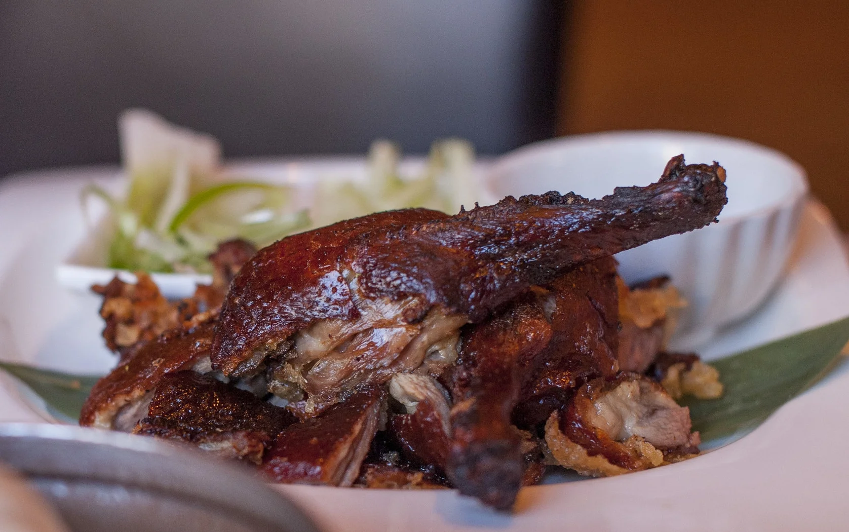  The classic Peking Duck serves up duck in between warm, steamed buns, topped with effervescent scallions, juicy cucumbers, with a tangy sweet hoisin sauce. 
