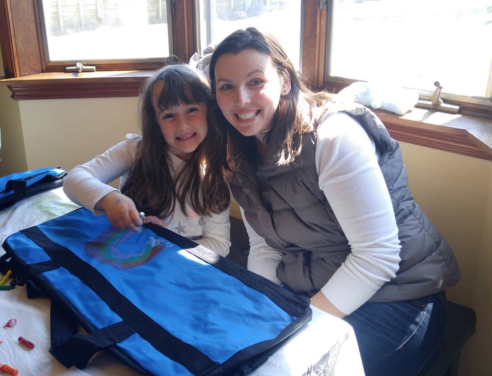  Carly Bemiss and daughter Emma, both of Greenlawn, decorate sweet cases for Rachael Risinger’s mission to provide 103 bags to local foster children in need.    