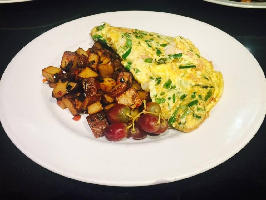  Honu’s wild mushroom and honey goat cheese omelet served with home fries and fresh fruit.    