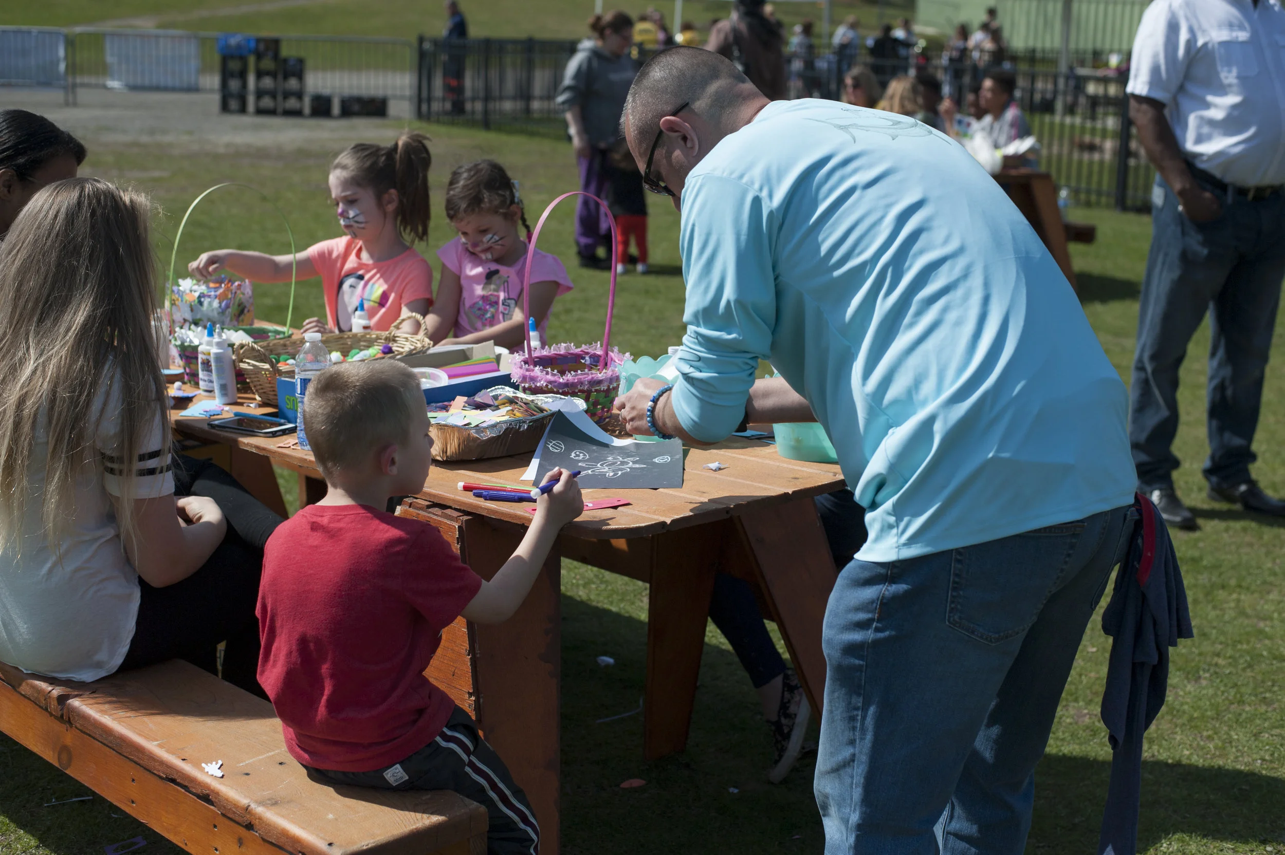  Christian Wisnowski, 7, makes a ‘Bunny Bookmark’ using construction paper and markers as his dad Chris helps glue his masterpiece together. 