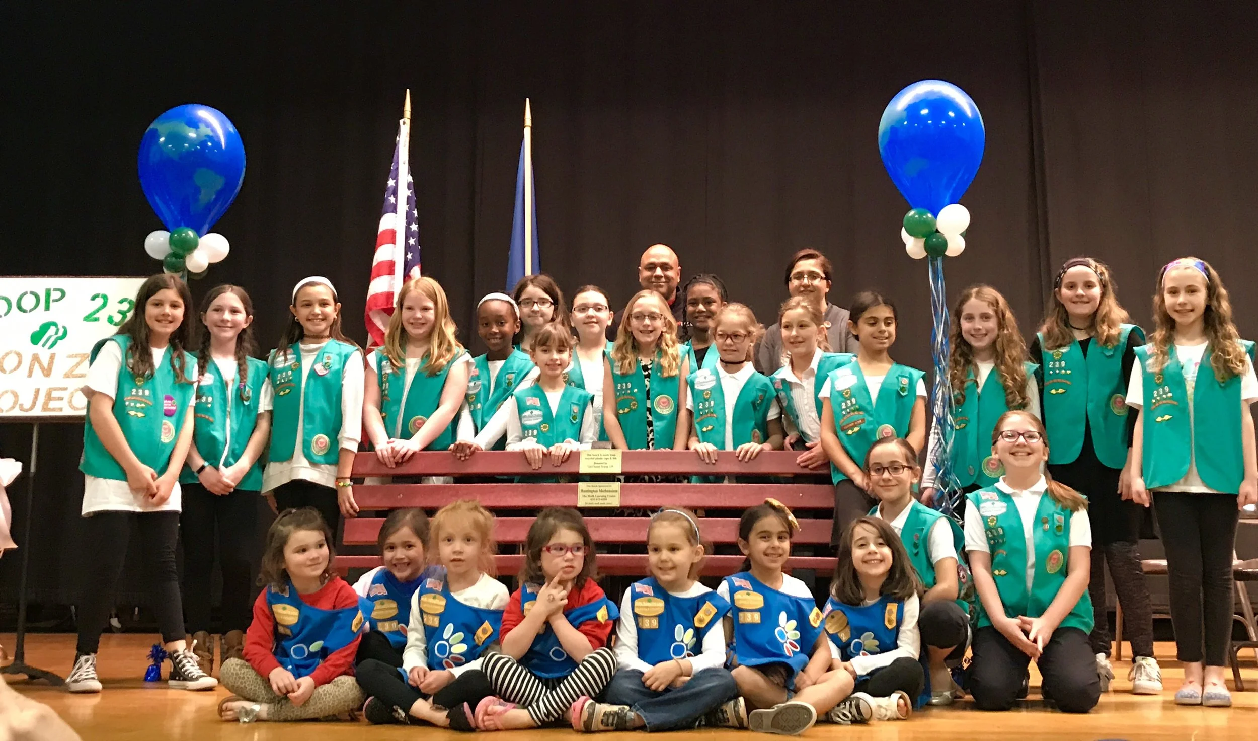 Troop Cuts Ribbon For  Bench Made Of Recyclables
