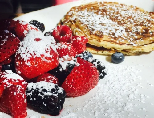 Treat mom next weekend to a meal on Mother’s Day, such as brunch at IMC Restaurant in Huntington. Pictured, IMC’s pancakes and seasonal fruit.