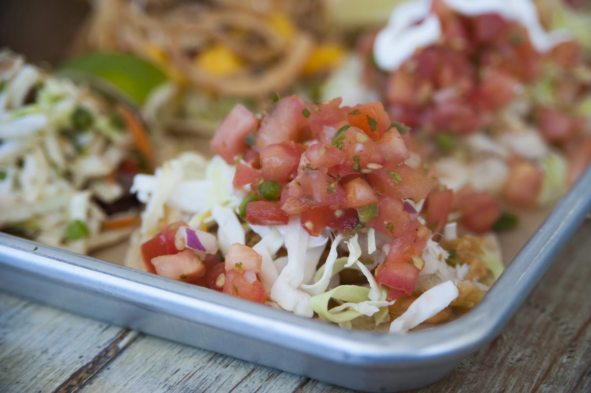  The Crispy Fish taco is accented with invigorating fresh tomato cilantro salsa, shredded cabbage and a three-chili spread. 