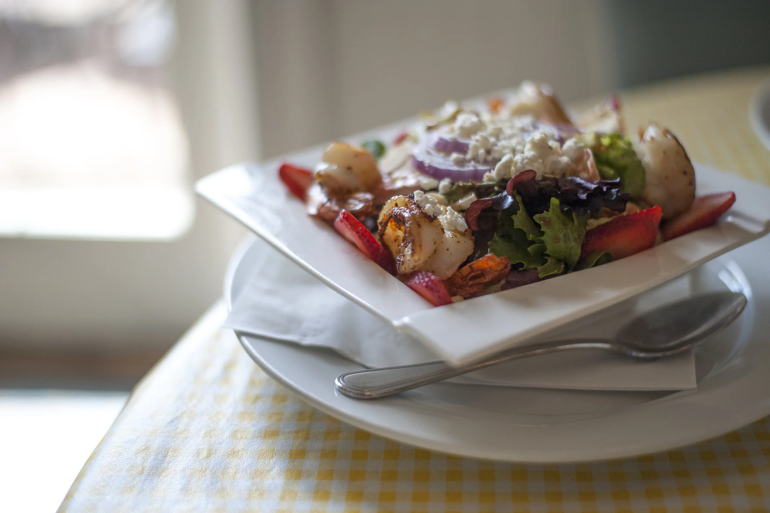  The Summer Strawberry &amp; Shrimp Salad tosses together char-grilled shrimp over mixed greens, freshly sliced strawberries, goat cheese, sliced almonds and red onion with a raspberry vinaigrette. 