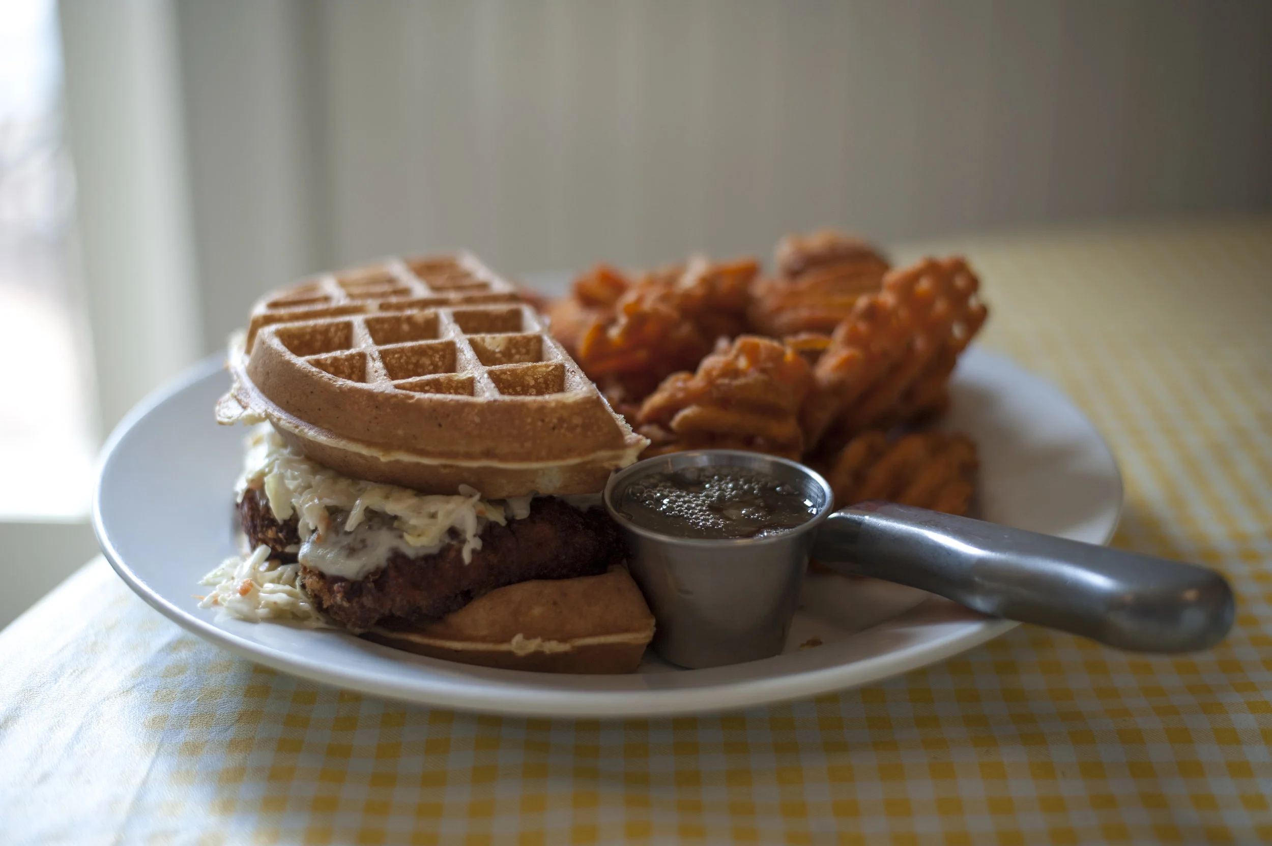  A soon-coming addition to the menu, the OMG! Chicken and Waffles Sandwich is both sweet and savory, all with a side of maple-infused honey mustard. 