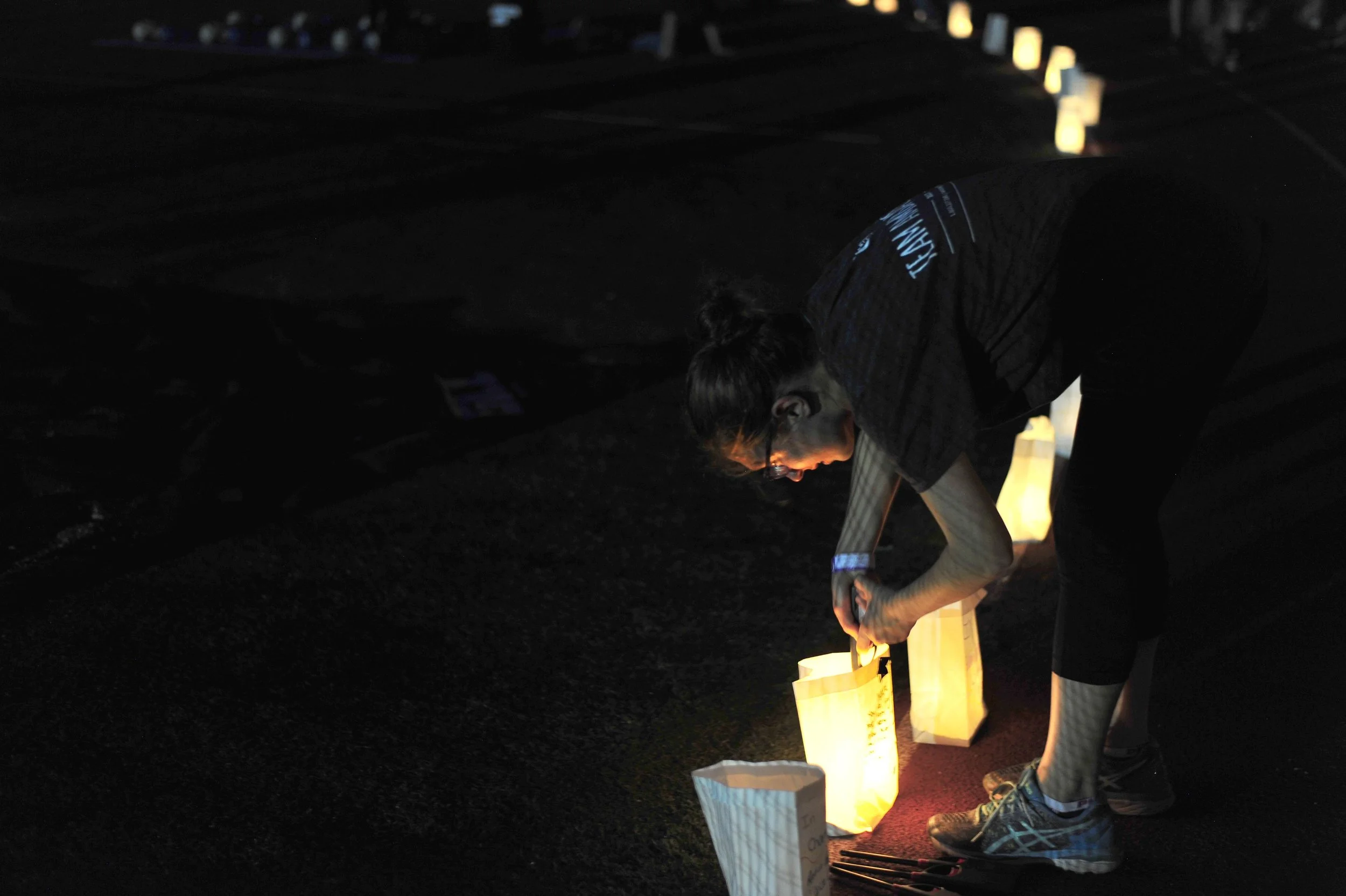   Photos by David Weber  White bags outfitted with candles and sand encircled the Commack High School track, each with a message to a loved one lost to cancer. At 9 p.m., student volunteers lit the candles for the Relay for Life Luminaria Ceremony. 