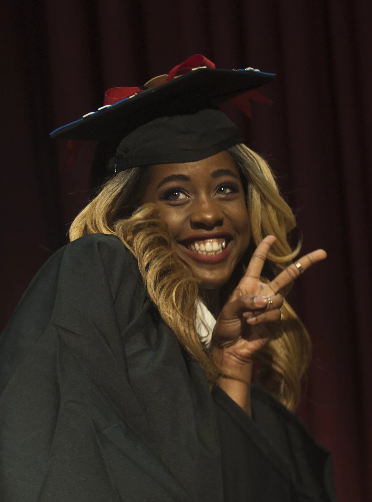  Graduate Chantel Martin flashes the peace sign after receiving her degree 