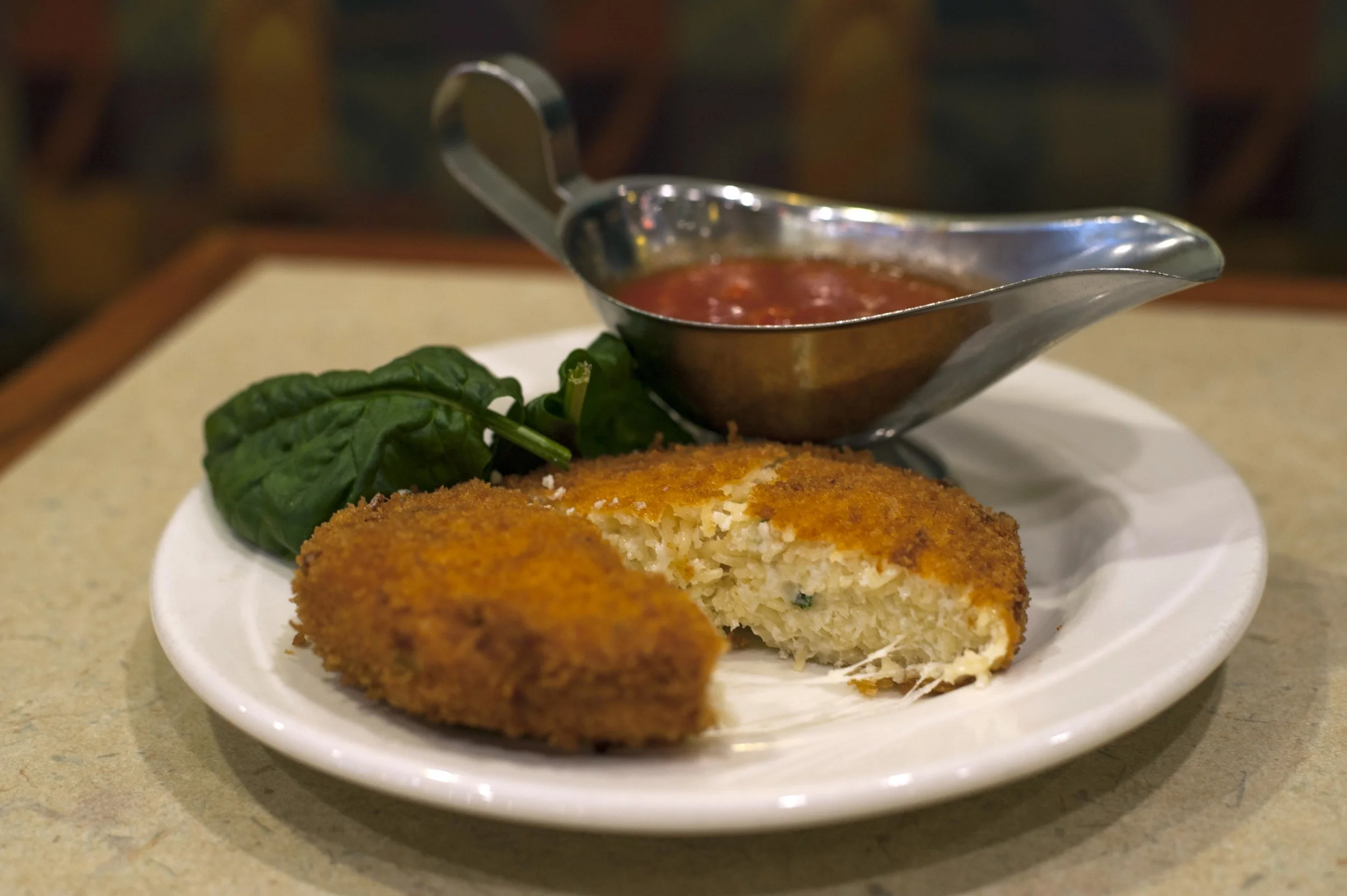  The Capellini Cake is a crispy helping of deep fried capellini pasta with ricotta, homemade mozzarella and grated parmigiana cheese served with a side of zesty, slightly sweet marinara sauce. 