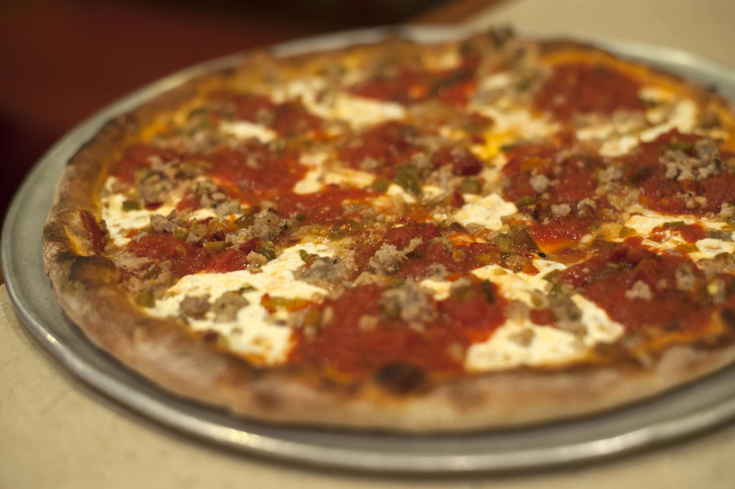  The 12-inch Fra Diavolo brick oven pizza is topped with plum tomato basil sauce with crumbled sausage, sliced hot cherry peppers and homemade fresh mozzarella. 