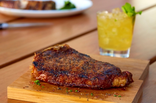 Make dad feel like a king this Father’s Day with an 18-ounce, 28-day Bone-In Dry-Aged Strip Steak, above, paired with a Gentleman’s Mule, inset, made with Basil Hayden’s Aged Bourbon courtesy of Del Frisco’s Grille in Huntington Station.