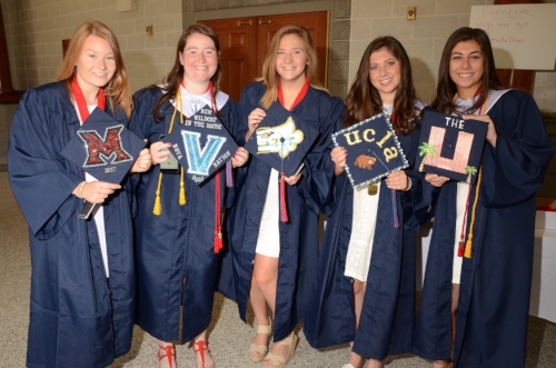  Members of the Cold Spring Harbor 2017 graduating class are all smiles as they hold up their decorative caps.    