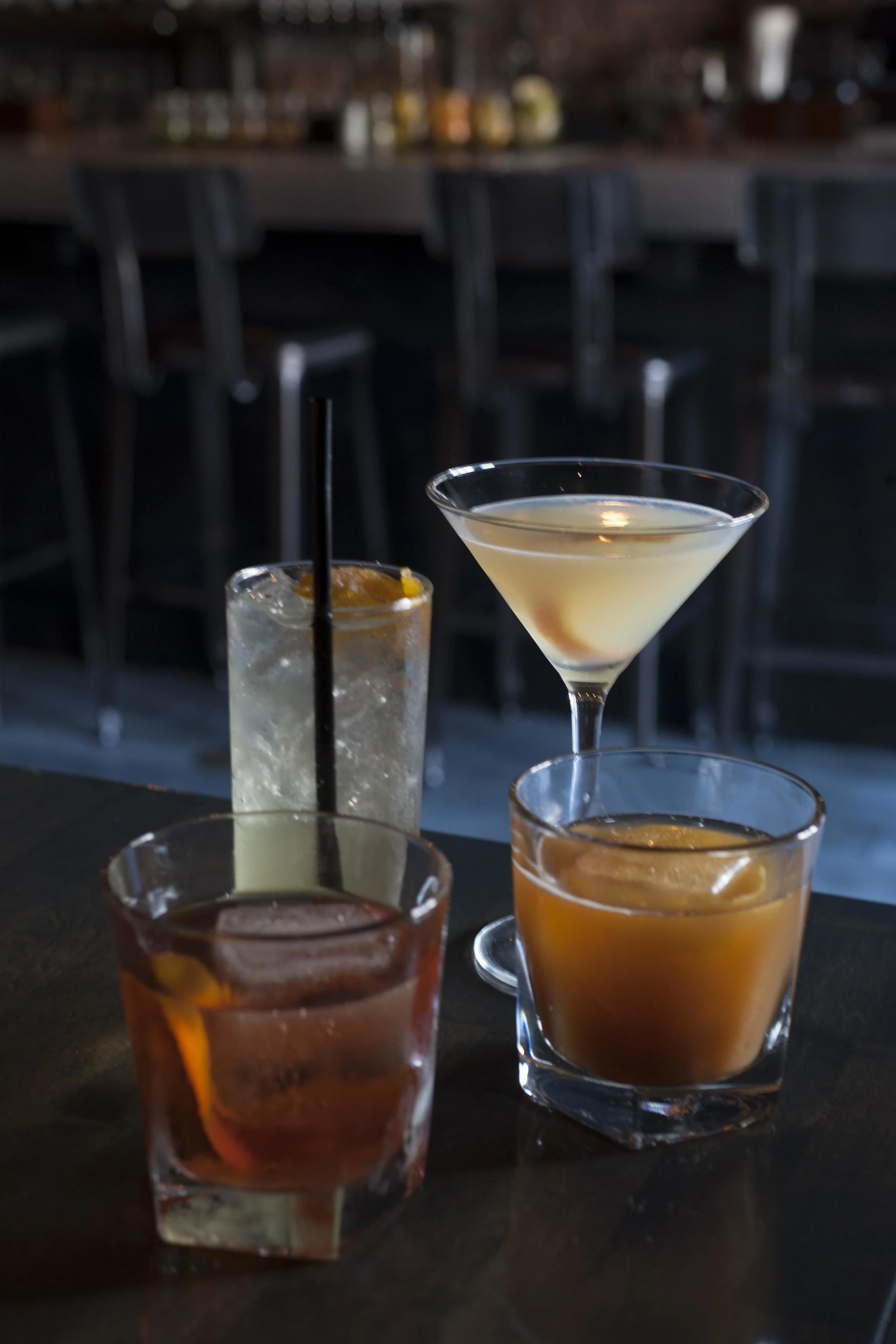  Pictured are some of Old Fields cocktails’, the summery Orange South Side (back-left) next to the Corpse Reviver II. In the front row, from left, are a classic New Orleans Sazerac and the Charleston Dragoon Punch. 