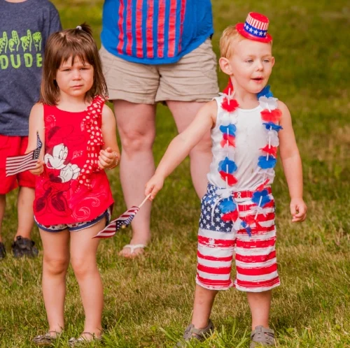  A young parade goer, donning the flag from head to toe, in Eatons Neck is enthralled by the marchers.    
