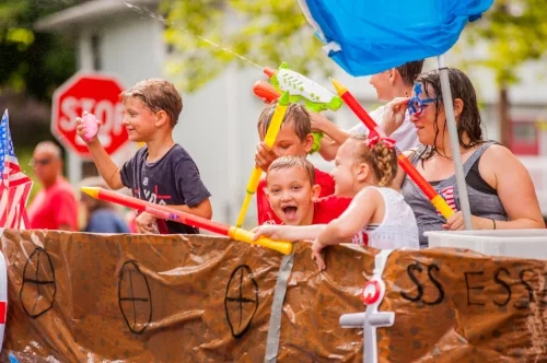  Children aboard vehicles in the parade were well-equipped for the yearly water fight. 