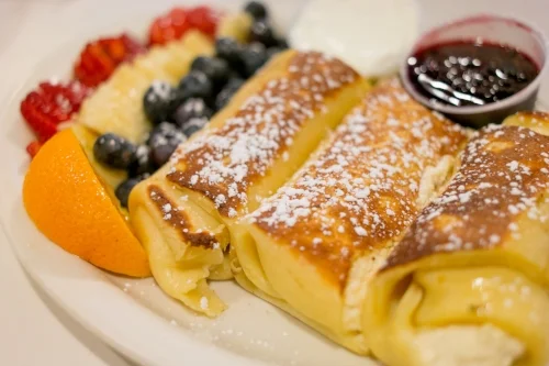  Marion’s Homemade Cheese Blintzes are filled with warm, mildly cheesy goodness that’s enhanced with a hint of cinnamon and powdered sugar, plated with fresh fruit, sour cream and Shipwreck’s renowned homemade jam. 