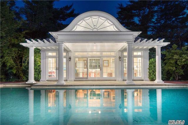  A pool house overlooking the in-ground saltwater pool has a full kitchen and lounge area. 