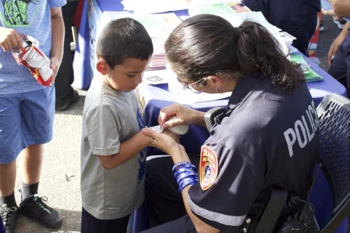 Kids and adults lined up to munch on some delicious popcorn during Tuesday’s annual National Night Out.    