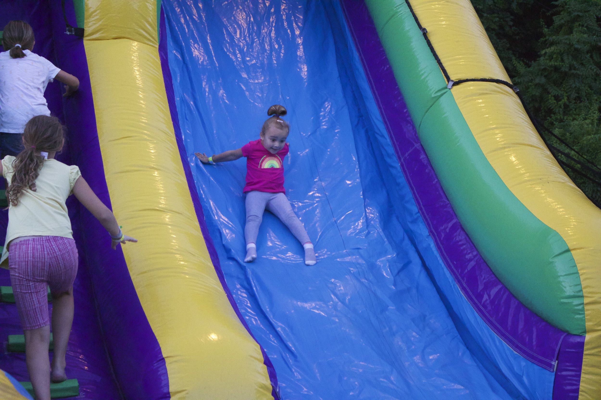  A girl slides down a bouncy house at the 10th Annual Northport Family Fun Night on Tuesday 