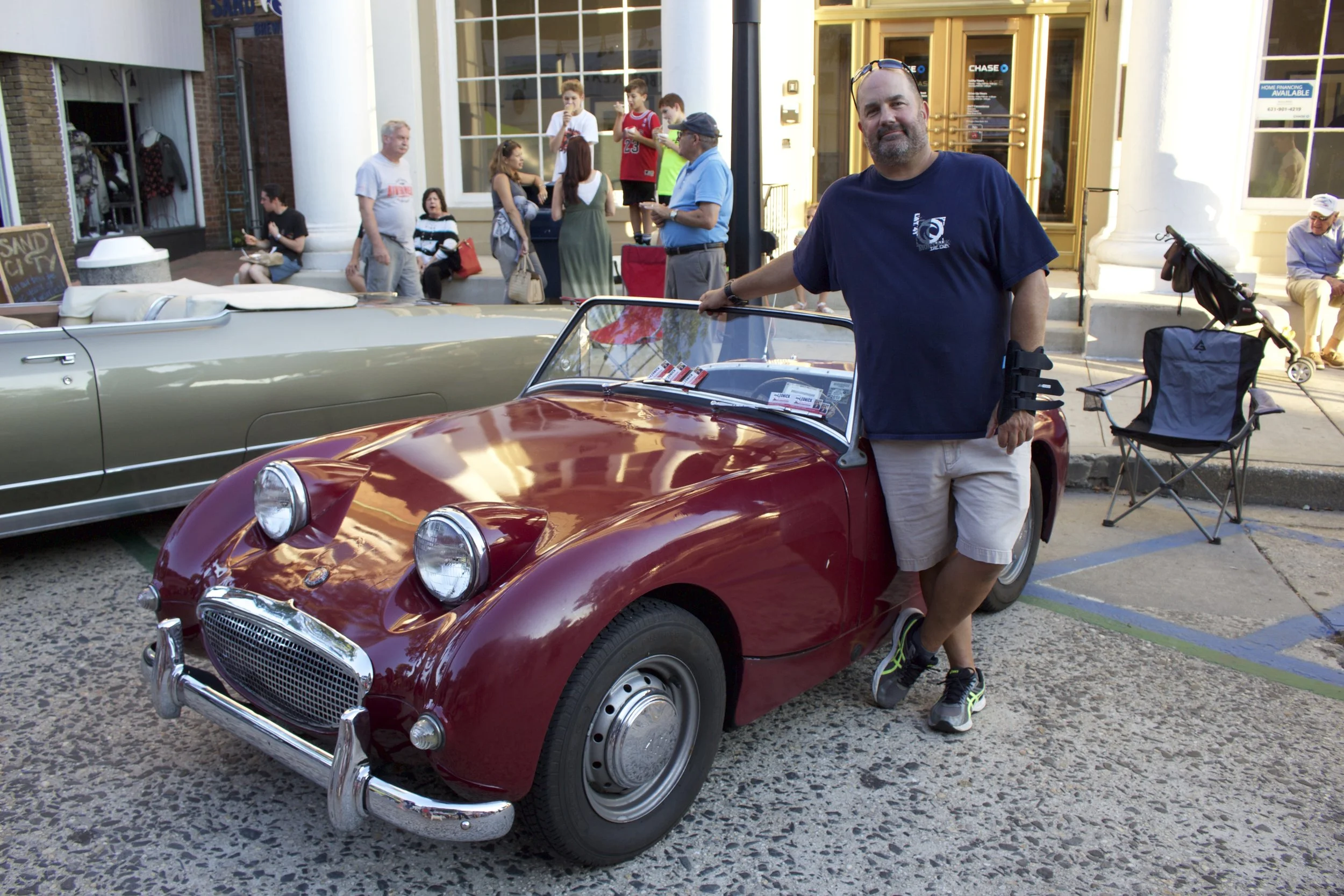  Mike Gozelski of East Northport, stands next to his 1959 Austin Healey Bug Eyed Sprite on display on Main Street. 
