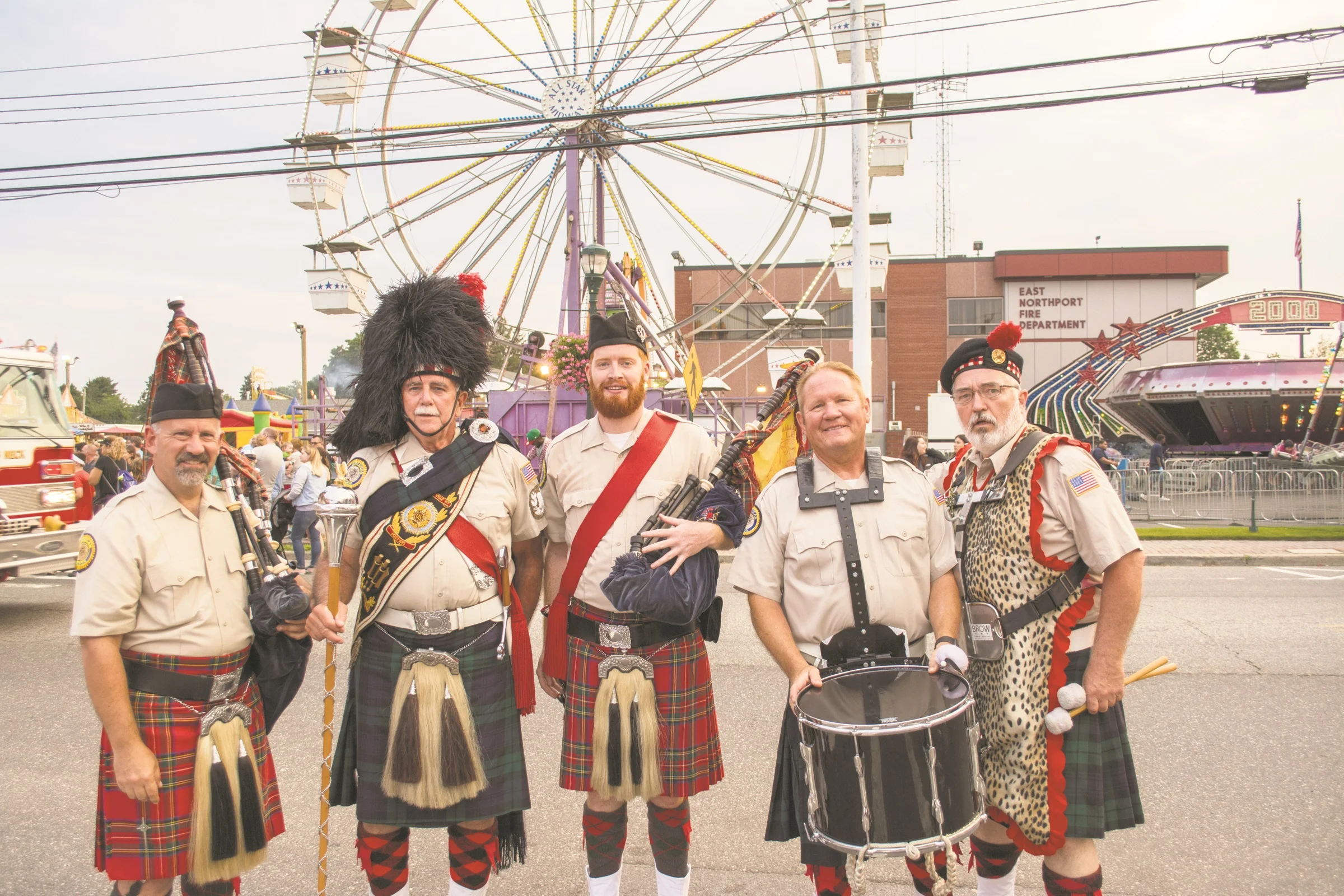  Members of the Amityville Highland Pipe Band are pictured after marching with the Smithtown Fire Department in Wednesday's parade.&nbsp; 