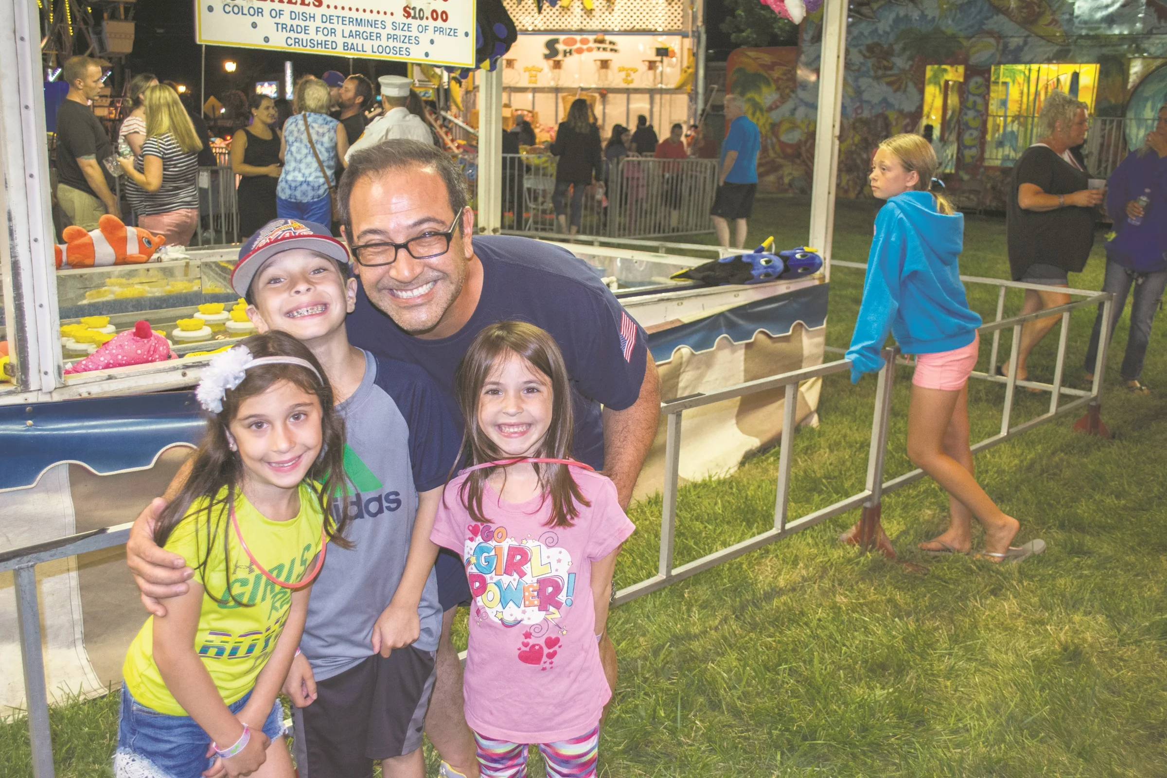  Glenn Lowy, back, and his family are first time attendees at the annual East Northport Fireman's Fair. 