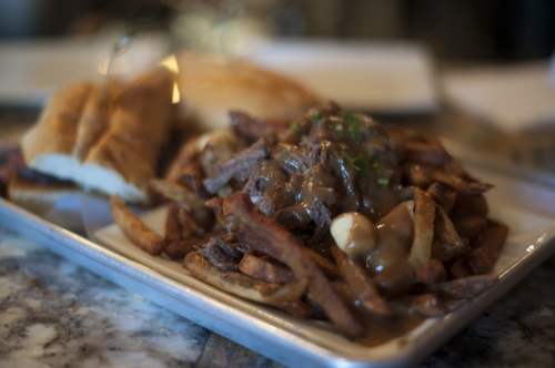  Foodies can relish in the short rib poutine, which is served with crispy house cut fries that are topped with warm cheese curds, and savory braised short rib, smothered in rich cabernet gravy. 