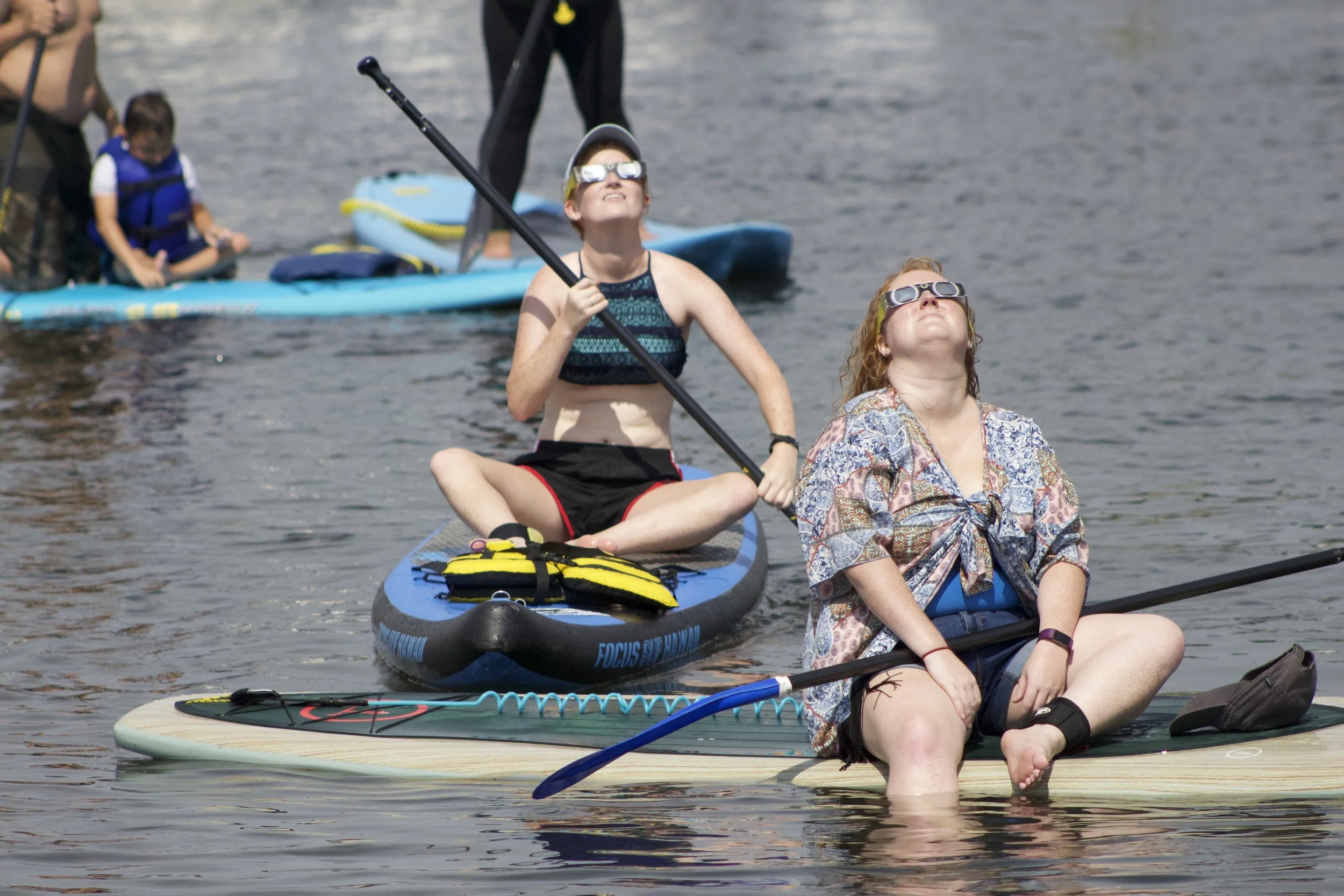   Throughout the afternoon, spectators enjoyed the water and glanced up at the sky, watching the moon inch further over the sun.   Long-Islander News photo/Janee Law  