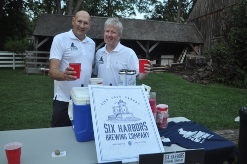   The guys behind Six Harbors Brewing Company, which is eyeing a New York Avenue space in Huntington village, serve up beer at the barbecue.  