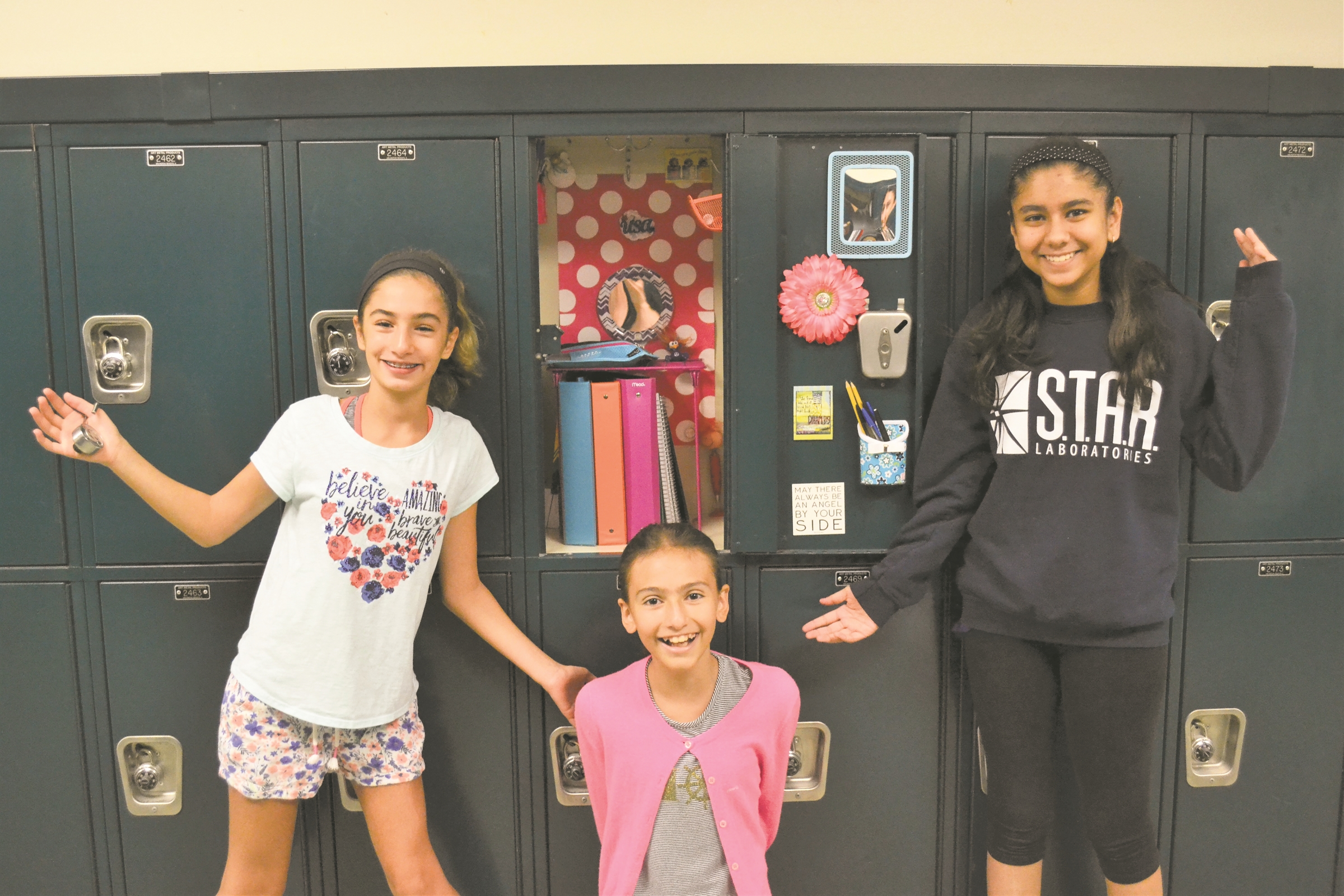   Harborfields seventh graders Gabby Dimartino, Alexa Palacios and Arya Sharma set up their Oldfield Middle School lockers on Tuesday.   &nbsp;Photo/Harborfields School District  