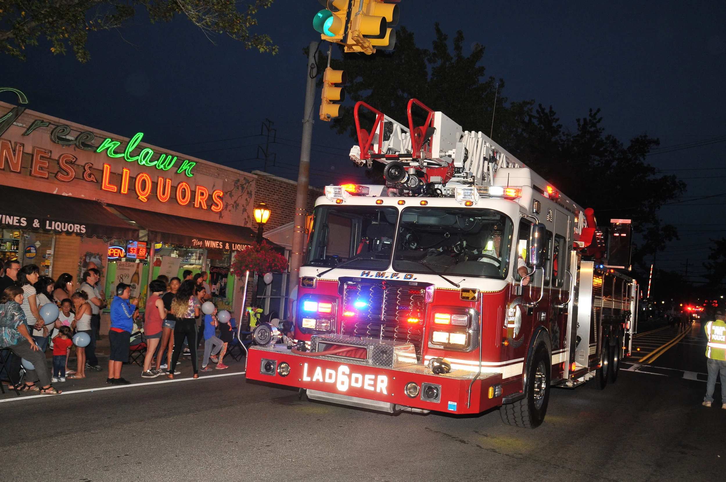   A Huntington Manor Fire Department Ladder Truck is ogled by parade goers.   Photo Courtesy of Steve Silverman  