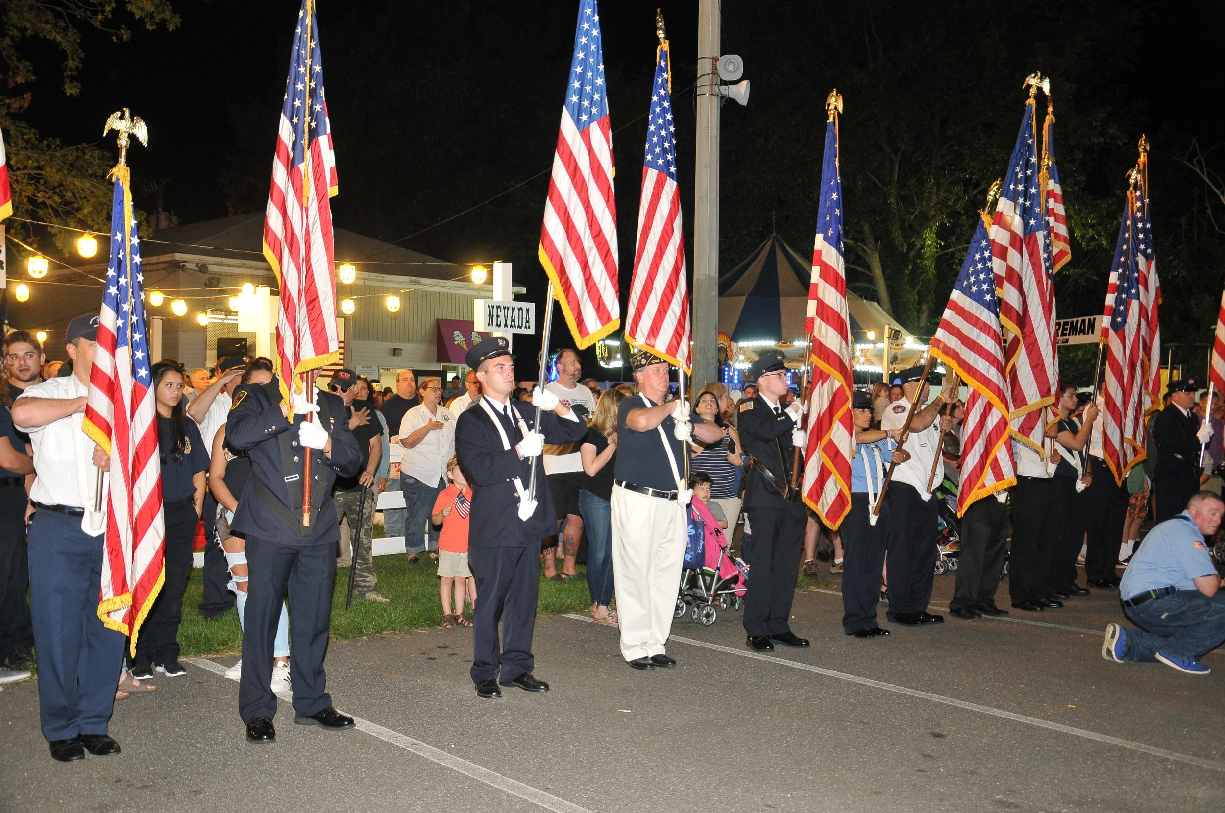   Flags are held high during the playing of the national anthem by the NYPD band.   Photo Courtesy of Steve Silverman  